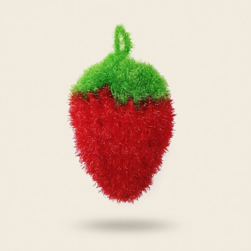 Strawbie strawberry-shaped kitchen scrubber in red glitter yarn with a green crocheted top
